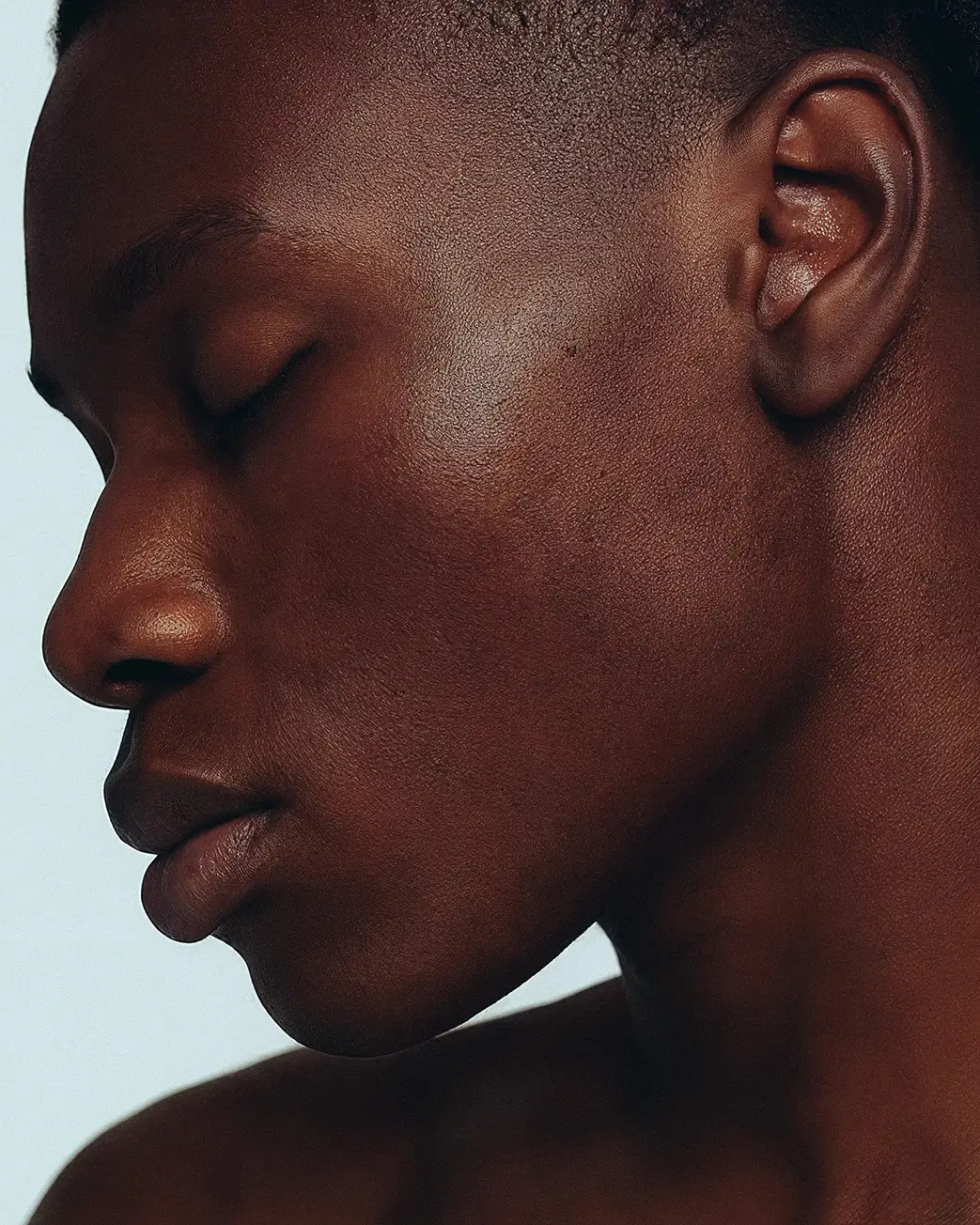 Close-up side profile of a man with smooth, healthy skin for natural skincare branding